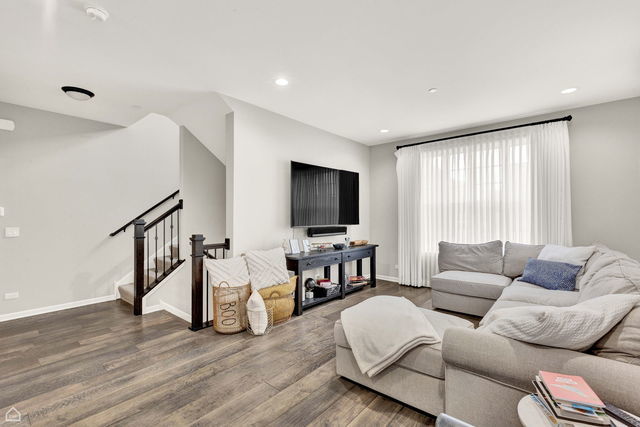 809 Lee Street Des Plaines, IL 60016 - Photo 3 of 18 a living room with furniture and a flat screen tv