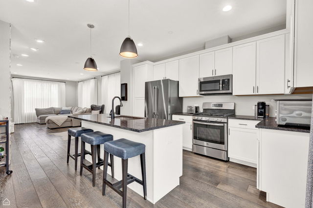 809 Lee Street Des Plaines, IL 60016 - Photo 5 of 18 a kitchen with stainless steel appliances a stove a sink a microwave a center island and a refrigerator