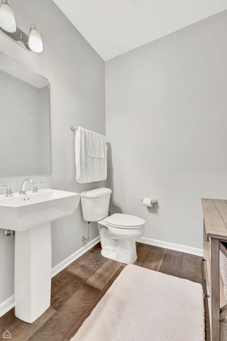 809 Lee Street Des Plaines, IL 60016 - Photo 8 of 18 a bathroom with a sink a toilet and mirror