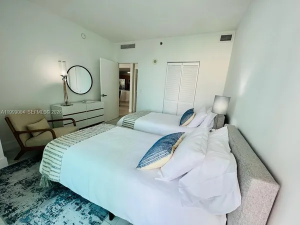 a bedroom with a bed and a mirror