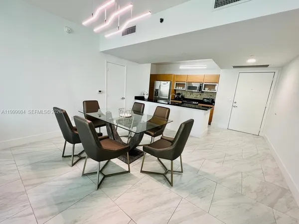 a view of a livingroom with furniture and a flat screen tv