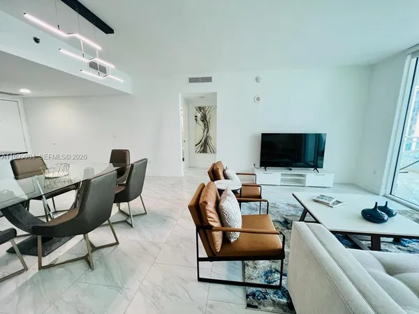 a work room with furniture and a flat screen tv