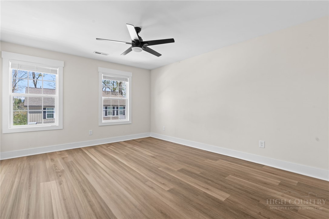 228 Stratford Lane Boone, NC 28607 - Photo 17 of 33 a view of an empty room with wooden floor and a window