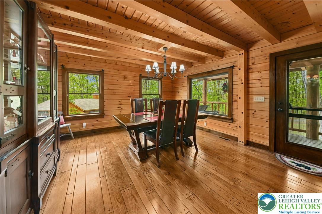 294 Nockamixon Road Kintnersville, PA 18930 - Photo 16 of 58 a view of a dining room with furniture window and wooden floor