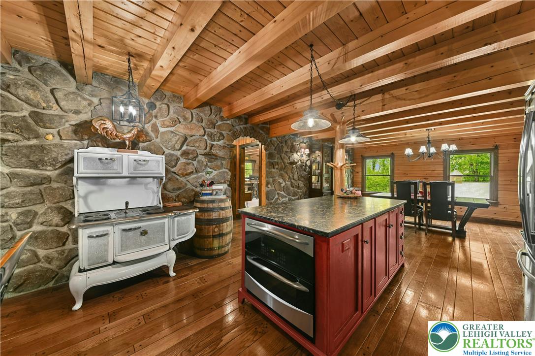 294 Nockamixon Road Kintnersville, PA 18930 - Photo 21 of 58 a kitchen with stainless steel appliances granite countertop a stove a sink and a microwave