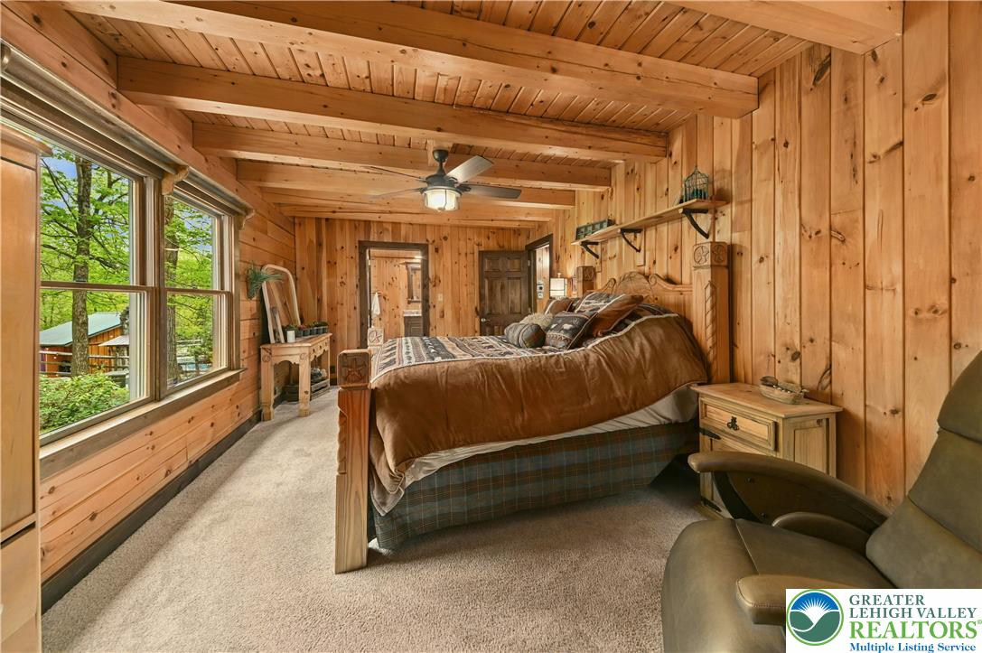 294 Nockamixon Road Kintnersville, PA 18930 - Photo 24 of 58 a bedroom with furniture and large windows