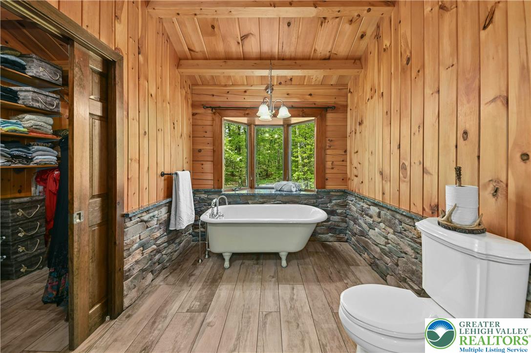 294 Nockamixon Road Kintnersville, PA 18930 - Photo 33 of 58 a bathroom with a sink a toilet a window and shower