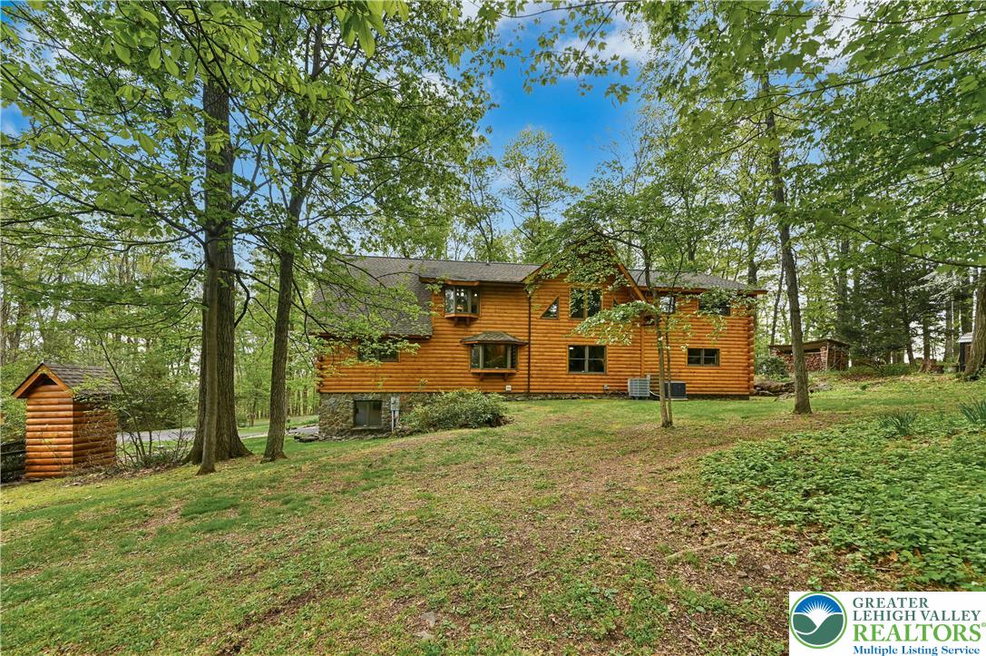 294 Nockamixon Road Kintnersville, PA 18930 - Photo 45 of 58 a view of a house with backyard and a tree