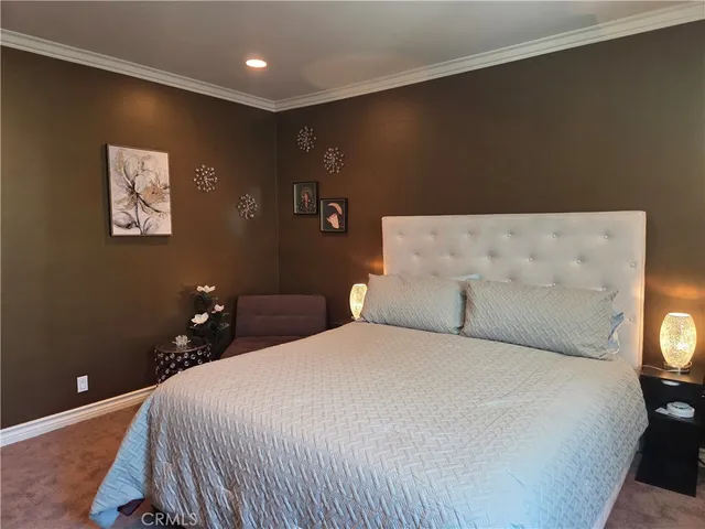 a bedroom with a bed and a night stand
