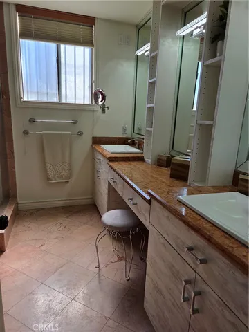 a room with a sink cabinets and a window