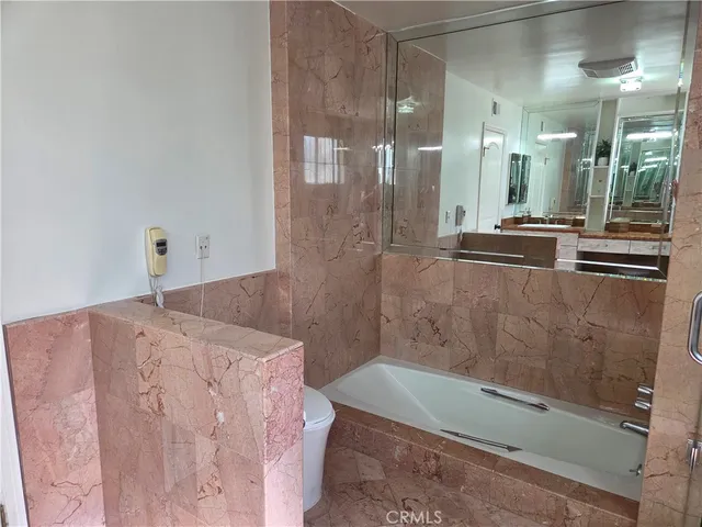 a bathroom with a bathtub and shower