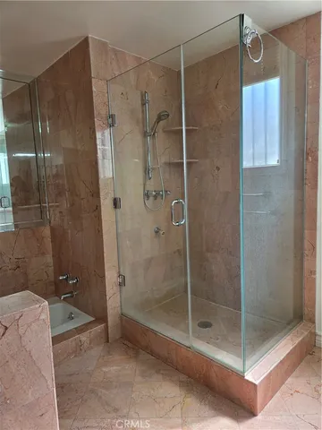 a bathroom with a shower and toilet