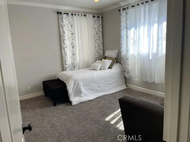 a bedroom with a bed and a chair