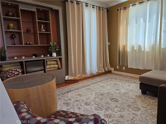 a living room with couches and kitchen view