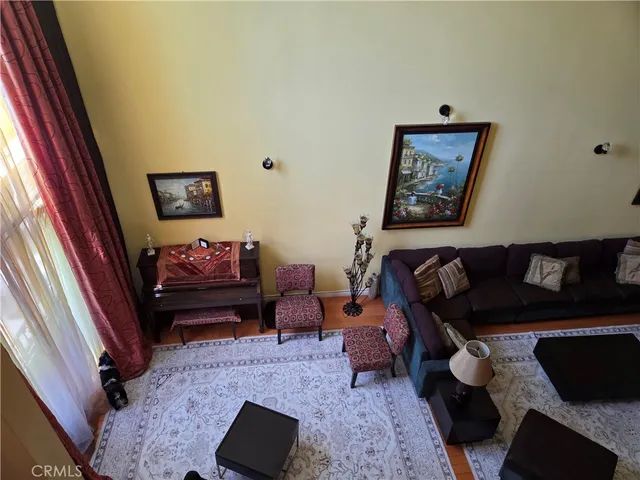 a living room with furniture and a flat screen tv with wooden floor