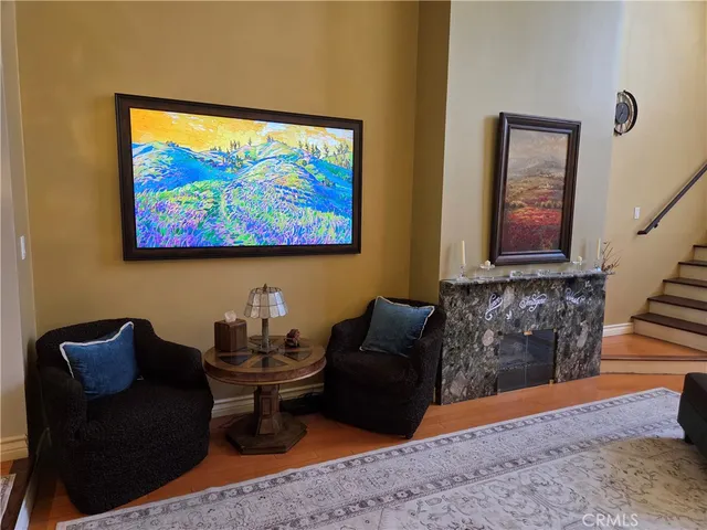 a living room with furniture and wall paintings