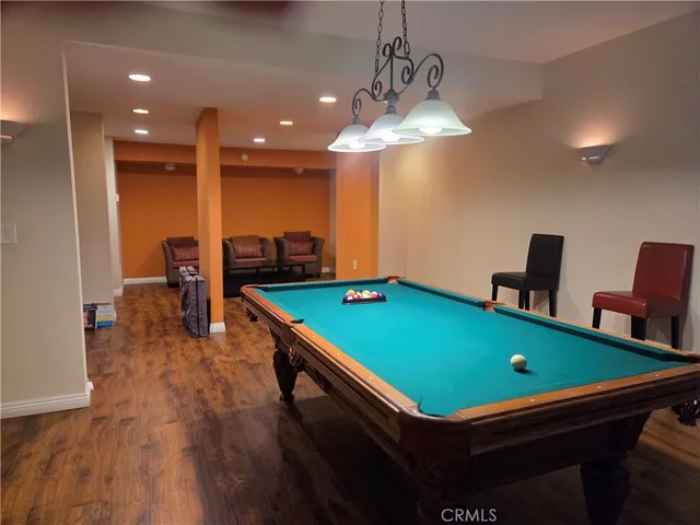 a room with pool table and windows