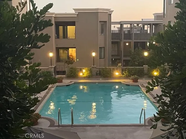 a view of a multi story residential apartment building with swimming pool