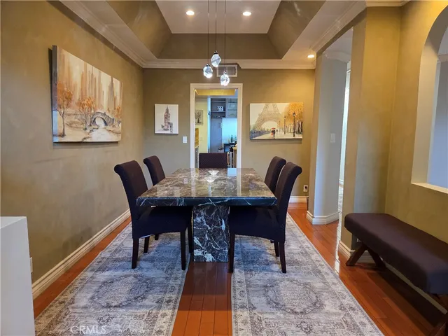 a view of a dining room with furniture and chandelier