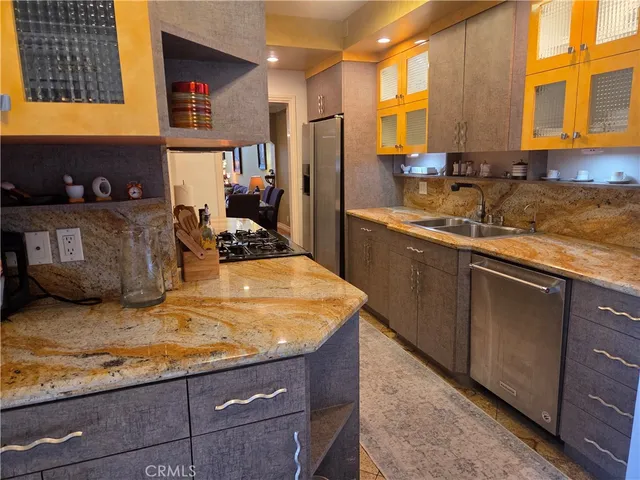 a kitchen with stainless steel appliances granite countertop a sink stove and cabinets