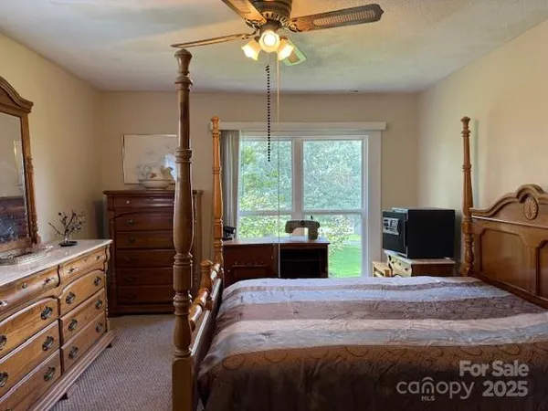 a bedroom with a bed and a flat tv screen