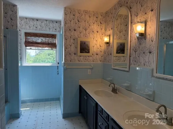 a bathroom with a sink vanity and mirror