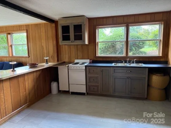 a kitchen with a sink stove and cabinets
