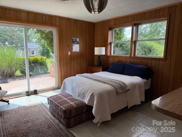 a bedroom with a bed and large window