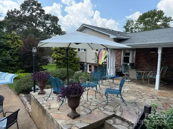 a view of a chair and tables in the balcony