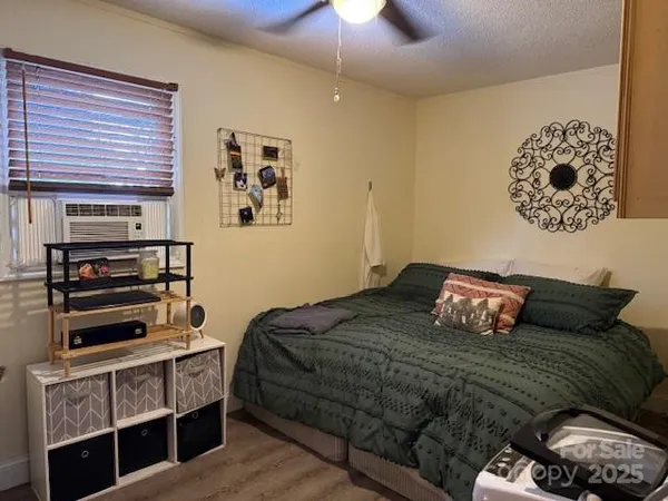 a bed sitting in a room next to a window