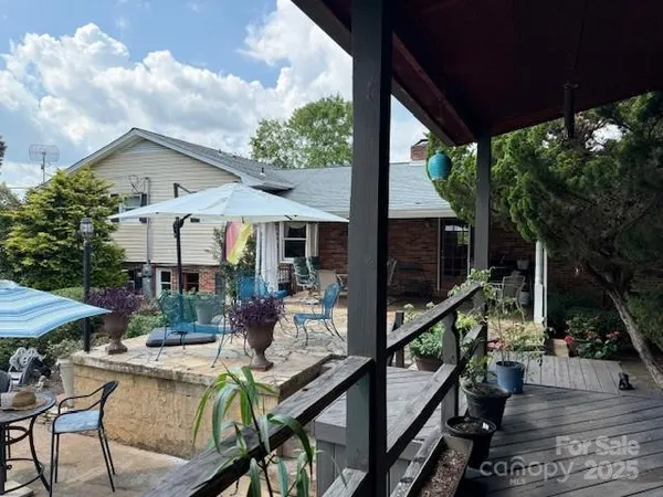 a room with stainless steel appliances kitchen island granite countertop lots of clutter