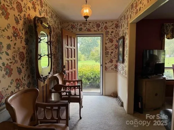 a view of a livingroom with furniture and a window