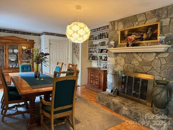 a view of a dining room with furniture and chandelier