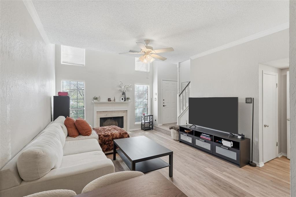 a living room with furniture a fireplace and a flat screen tv
