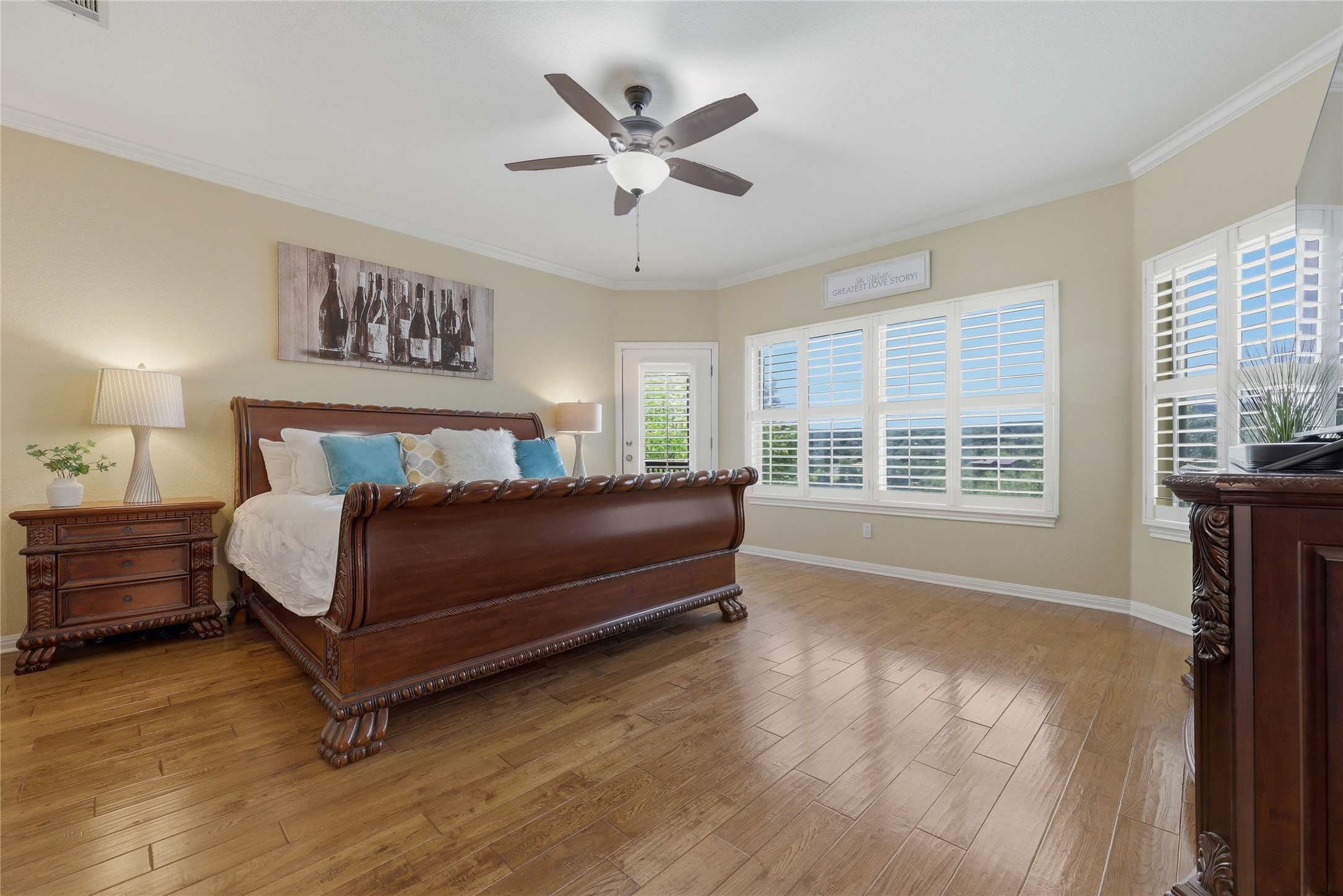10802 Beach Road Leander, TX 78641 - Photo 18 of 40 Large primary bedroom on the main level with hardwood floors and natural light.