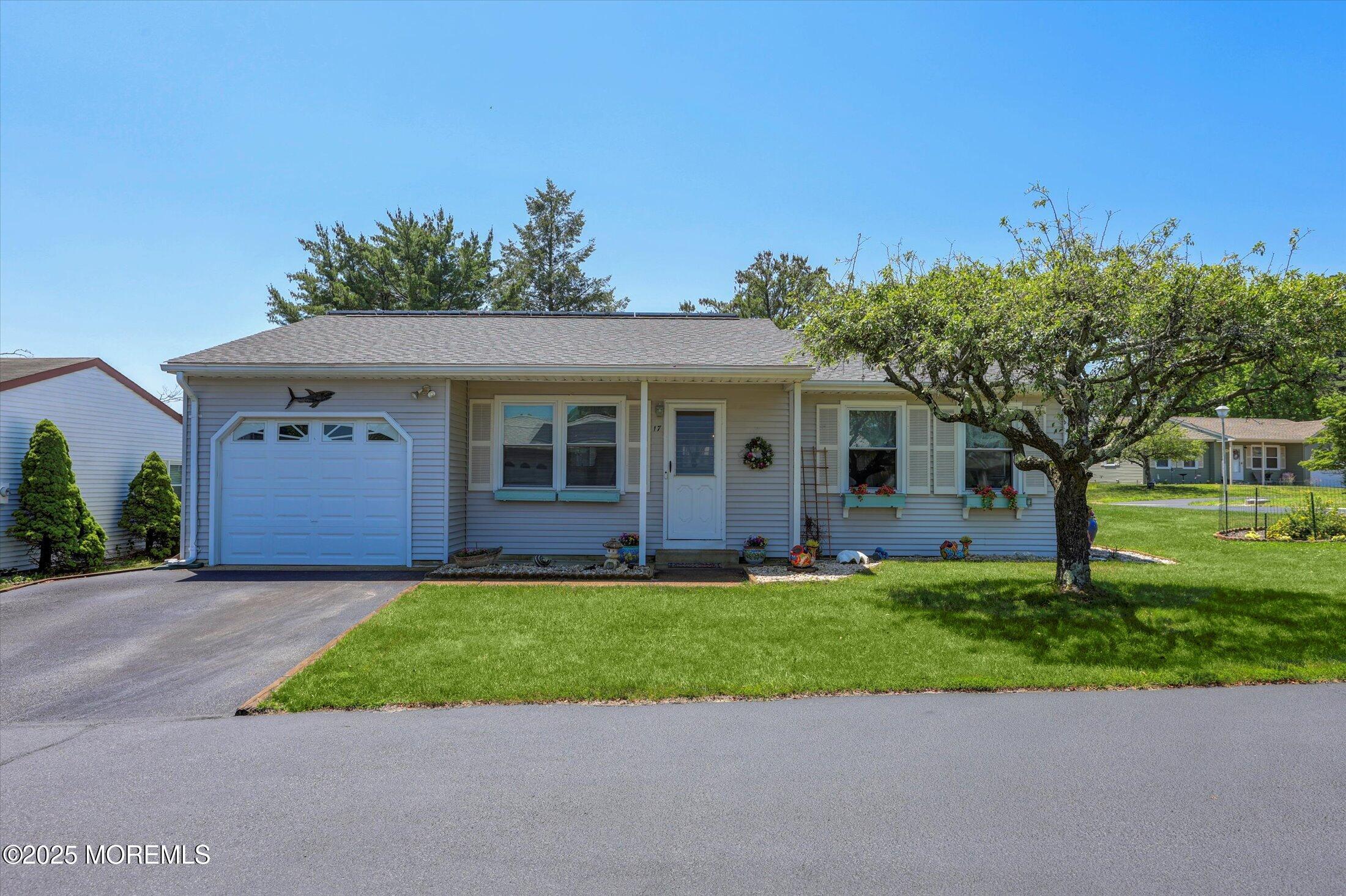 17 Churchill Road, Unit 71 Whiting, NJ 08759 - Photo 1 of 29 a front view of a house with a garden and trees