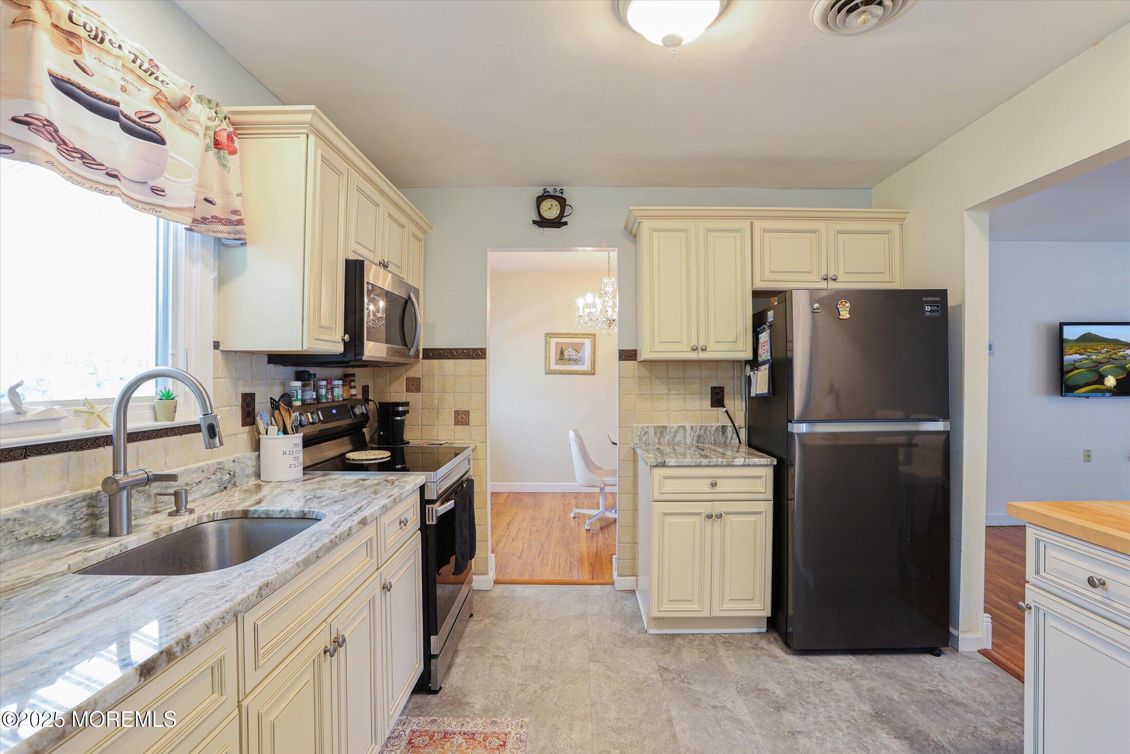 17 Churchill Road, Unit 71 Whiting, NJ 08759 - Photo 11 of 29 a kitchen with stainless steel appliances granite countertop a refrigerator stove and sink