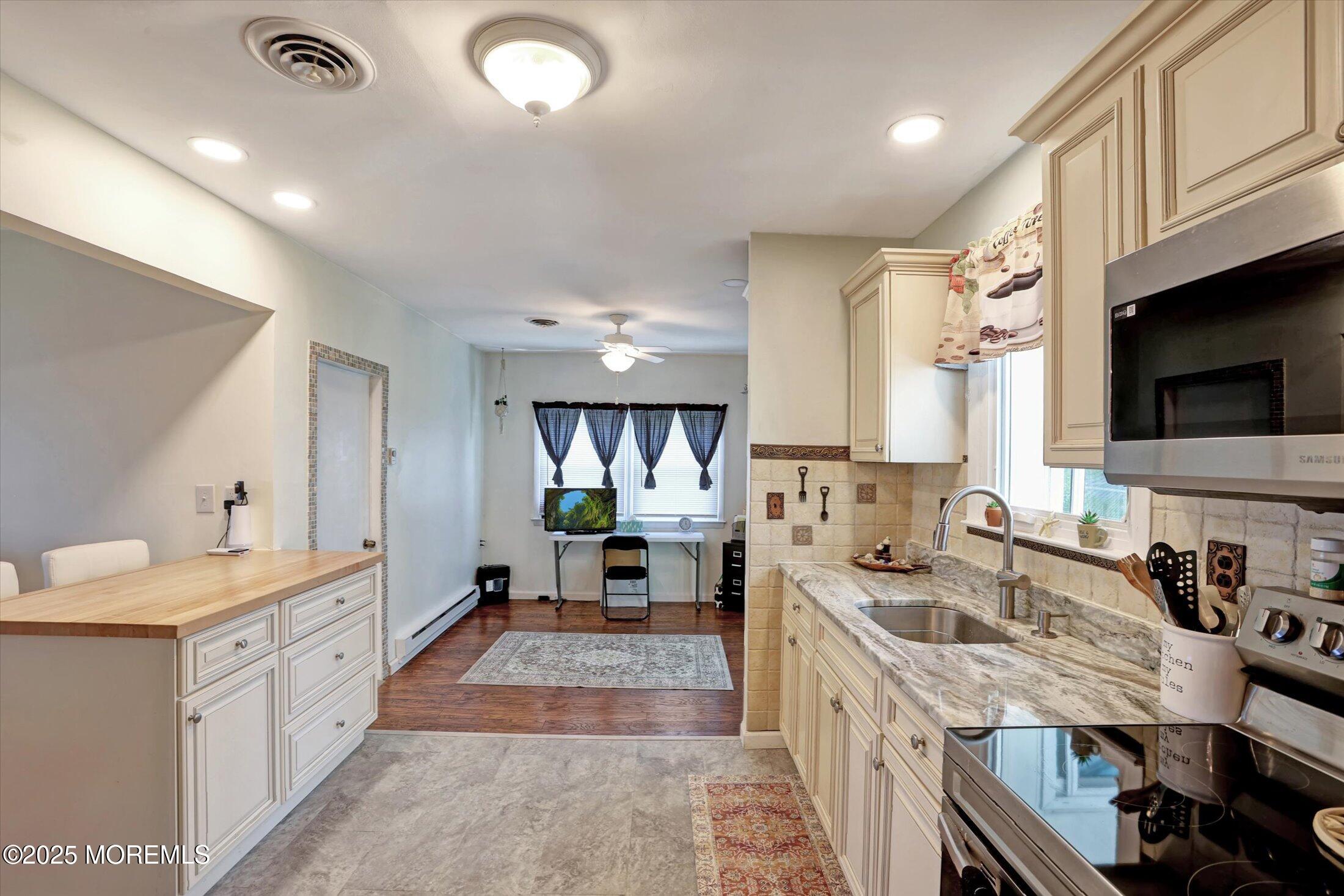 17 Churchill Road, Unit 71 Whiting, NJ 08759 - Photo 12 of 29 a kitchen with a sink stove and cabinets