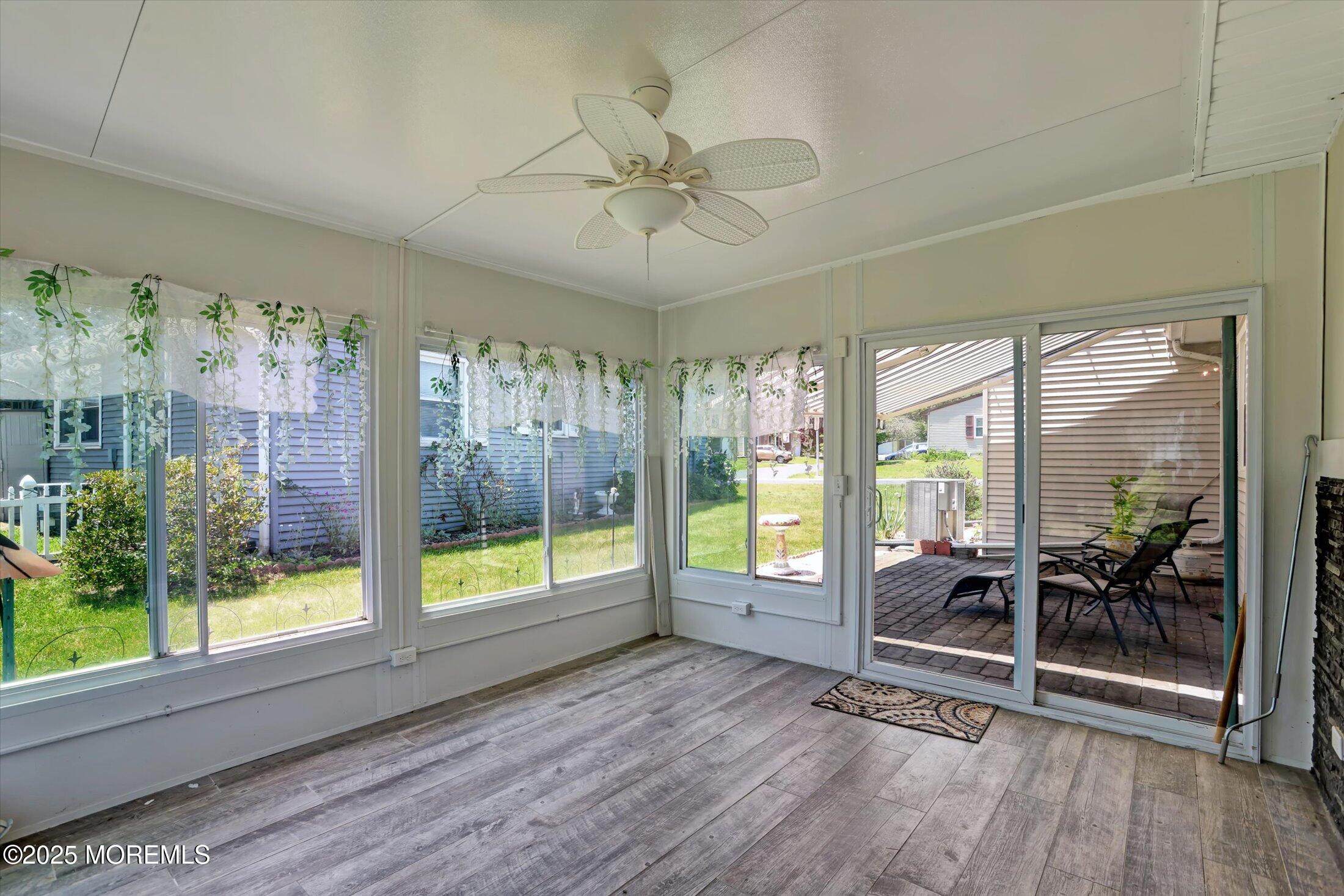 17 Churchill Road, Unit 71 Whiting, NJ 08759 - Photo 20 of 29 a view of a livingroom with wooden floor and a large window