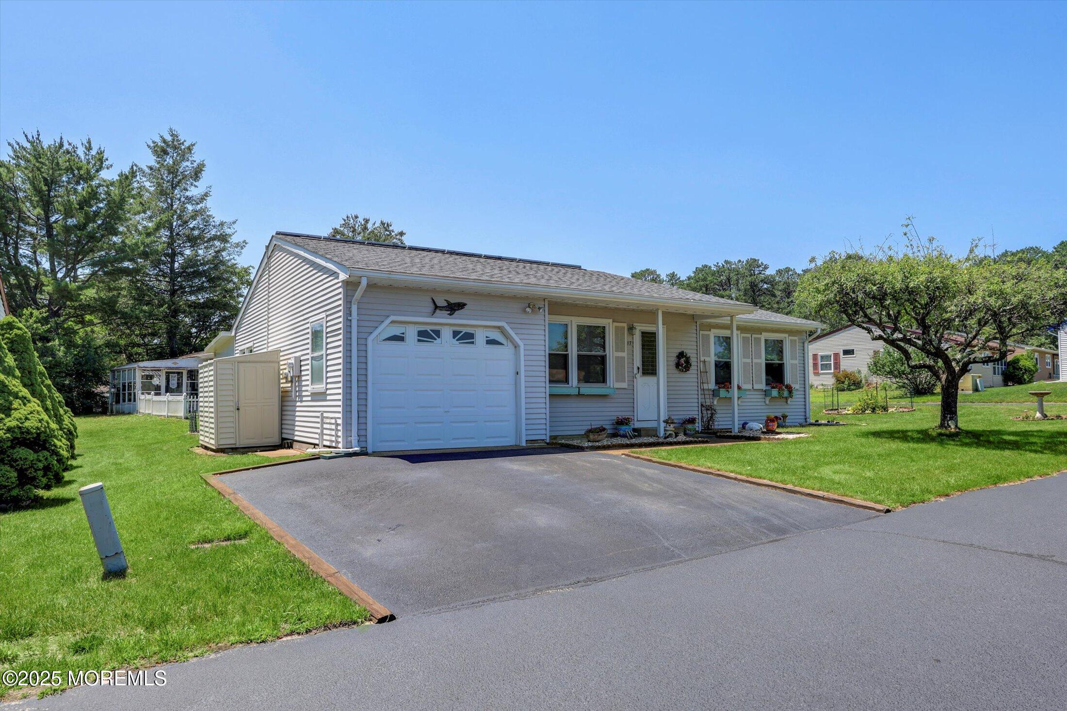 17 Churchill Road, Unit 71 Whiting, NJ 08759 - Photo 2 of 29 a front view of a house with a yard and garage