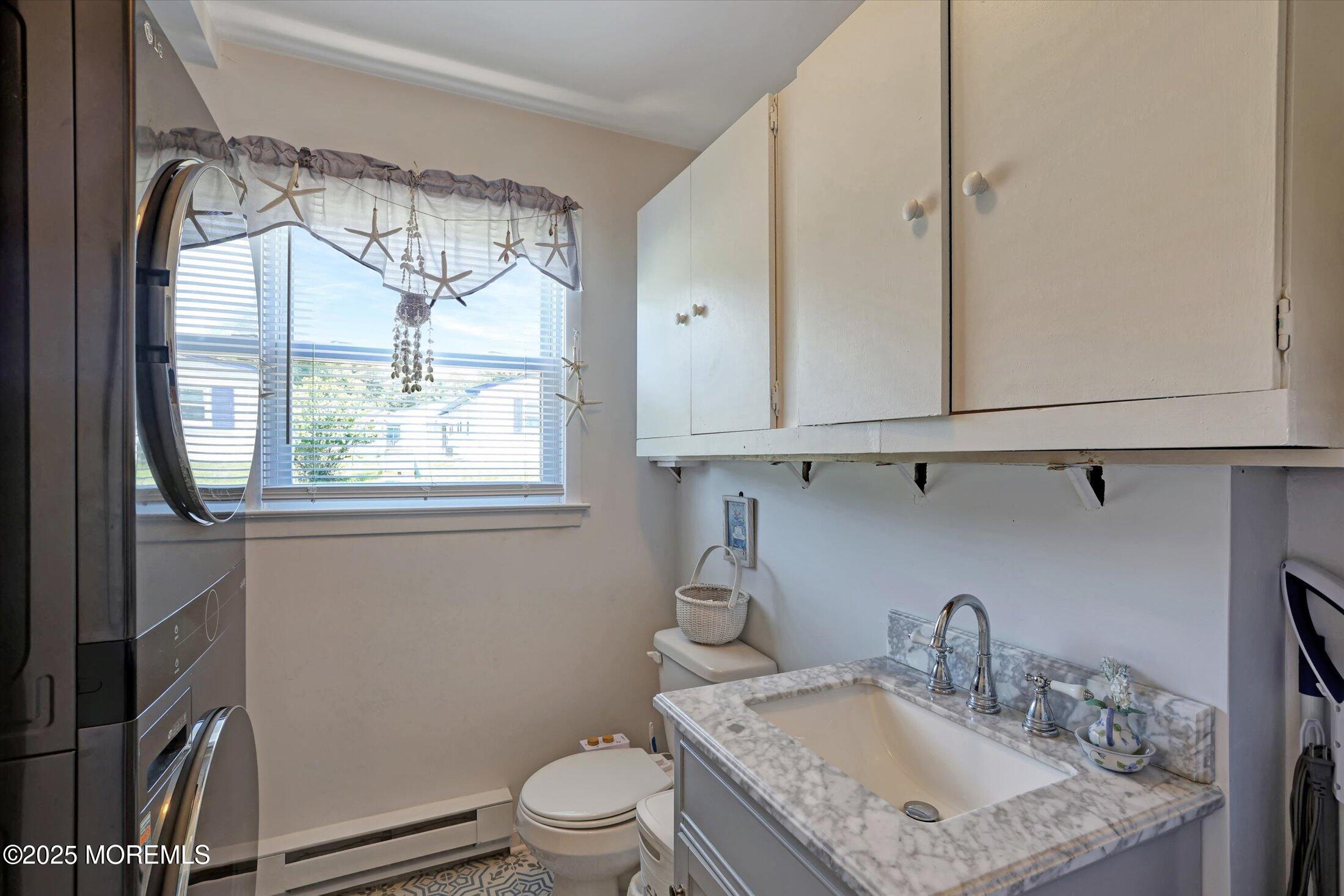 17 Churchill Road, Unit 71 Whiting, NJ 08759 - Photo 23 of 29 a bathroom with a granite countertop sink a toilet and a mirror