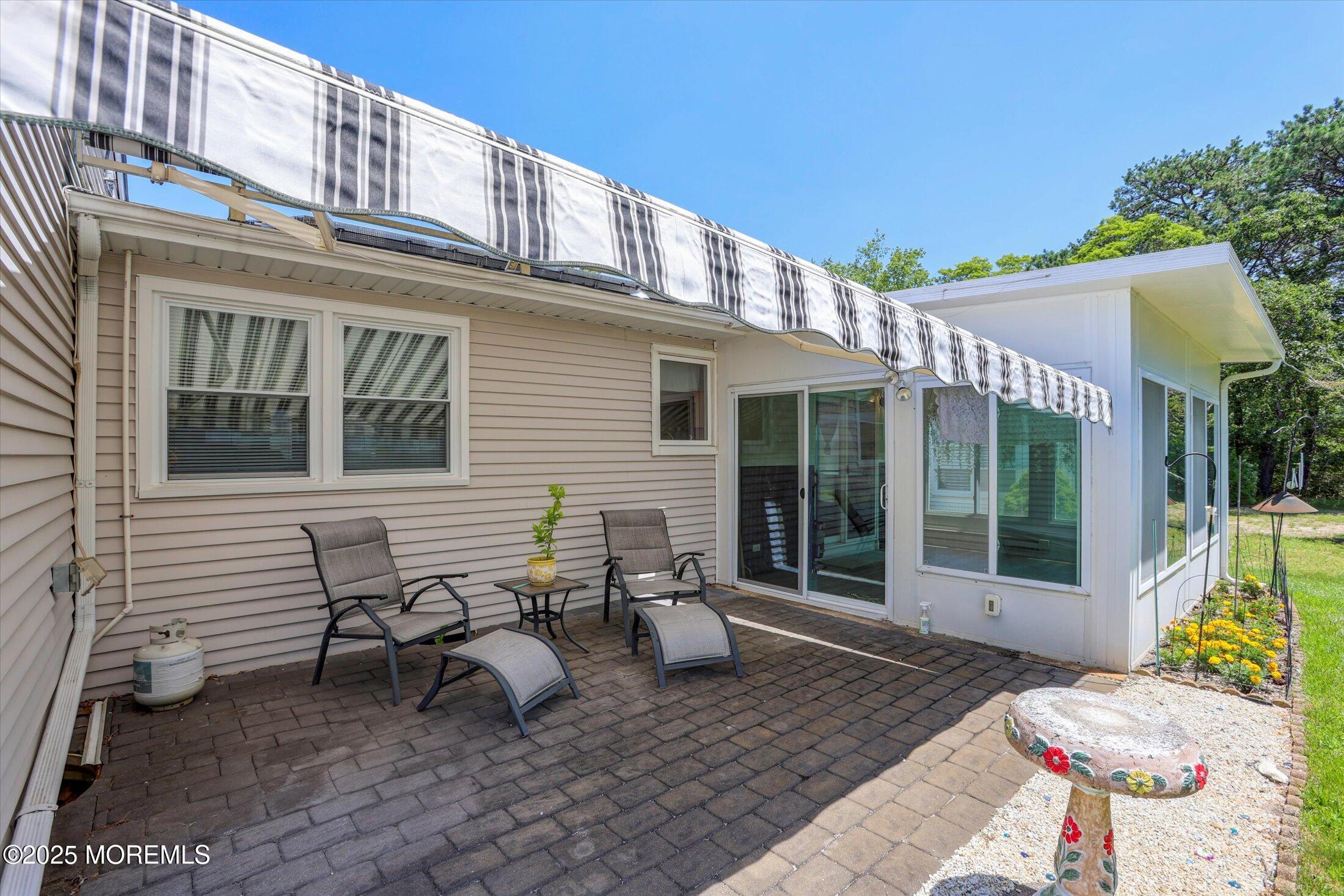 17 Churchill Road, Unit 71 Whiting, NJ 08759 - Photo 25 of 29 a view of a patio with couple of chairs and a fountain