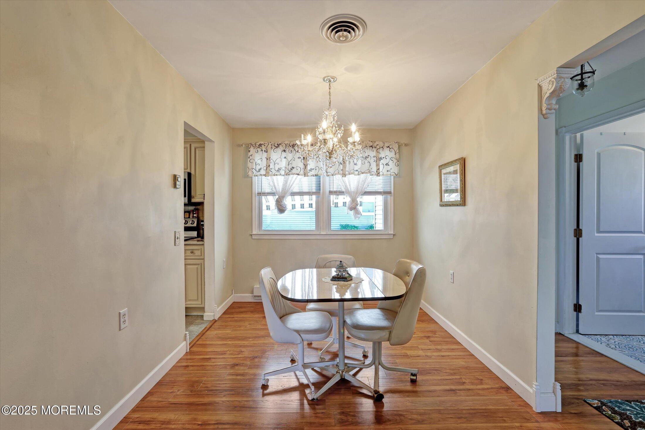 17 Churchill Road, Unit 71 Whiting, NJ 08759 - Photo 7 of 29 a view of a dining room with furniture window and wooden floor