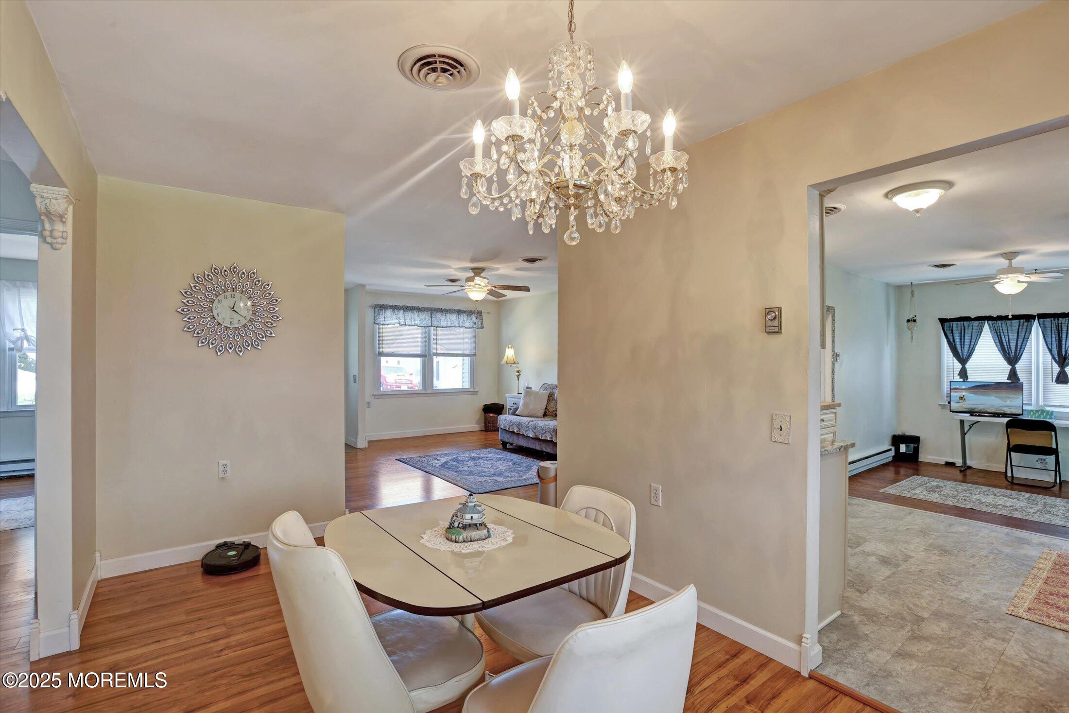 17 Churchill Road, Unit 71 Whiting, NJ 08759 - Photo 8 of 29 a view of a dining room with furniture and chandelier