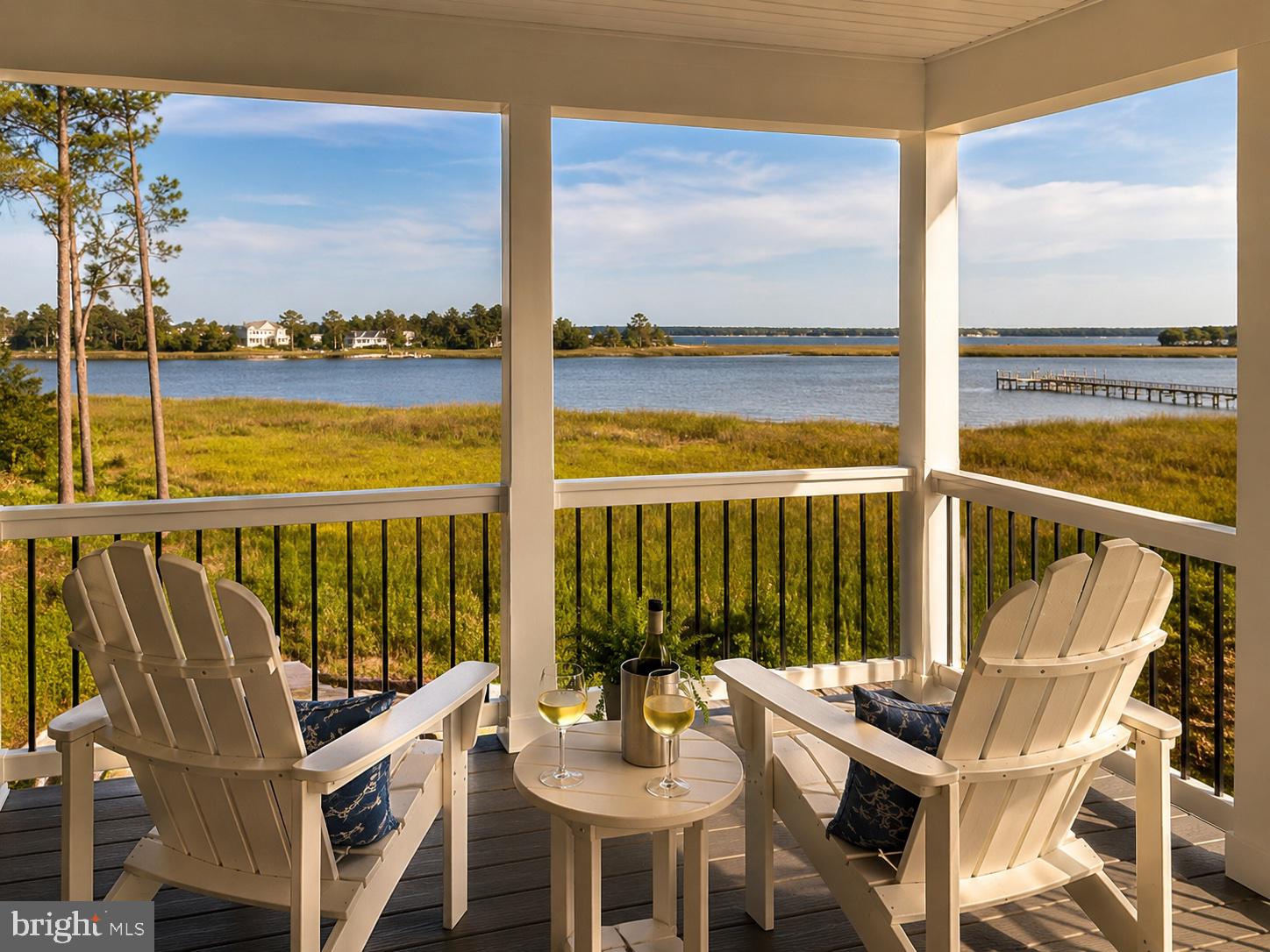 16242 Thomas Road Piney Point, MD 20674 - Photo 2 of 75 a view of a balcony with table and chairs and wooden floor