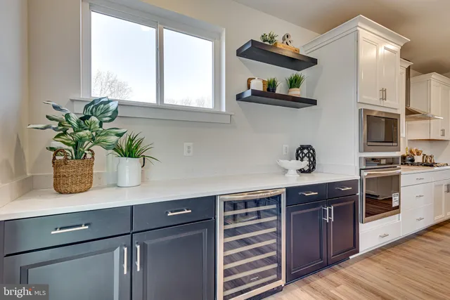a kitchen with stainless steel appliances granite countertop a sink a stove and cabinets