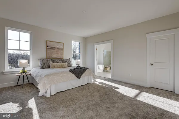 a bedroom with bed and a large window