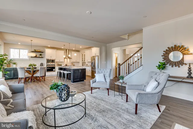 a living room with furniture kitchen view and a table