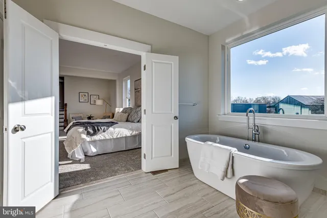 a living room with furniture and a large mirror