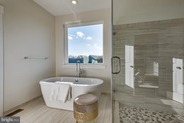 a bathroom with a bathtub and shower